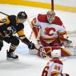 
              Calgary Flames goaltender Jacob Markstrom (25) blocks a shot by Pittsburgh Penguins' Drew O'Connor (10) during the first period of an NHL hockey game in Pittsburgh, Thursday, Oct. 28, 2021. (AP Photo/Gene J. Puskar)
            