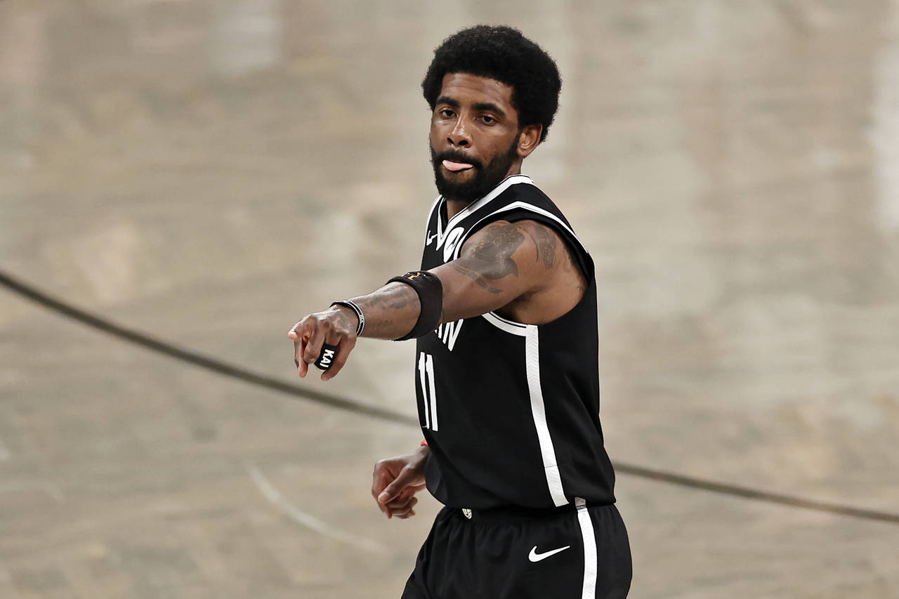 FILE - In this June 5, 2021, file photo, Brooklyn Nets guard Kyrie Irving (11) reacts against the M...