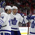 
              Toronto Maple Leafs' Auston Matthews (34) is congratulated on his goal by teammates during the first period of an NHL hockey game against the Carolina Hurricanes in Raleigh, N.C., Monday, Oct. 25, 2021. (AP Photo/Karl B DeBlaker)
            