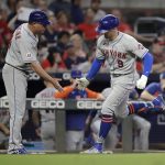 
              New York Mets' Brandon Nimmo, right, celebrates with third base coach Gary Disarcina after hitting a home run off Atlanta Braves' Spencer Strider in the seventh inning of a baseball game Friday, Oct. 1, 2021, in Atlanta. (AP Photo/Ben Margot)
            
