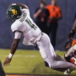 
              Oklahoma State defensive end Collin Oliver (30) brings down Baylor quarterback Gerry Bohanon (11) in the second half of an NCAA college football game, Saturday, Oct. 2, 2021, in Stillwater, Okla. (AP Photo/Sue Ogrocki)
            