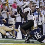 
              Navy safety Kevin Brennan (7) breaks up a pass intended for UCF wide receiver Nate Craig-Myers, center, as cornerback Jamal Glenn (16) helps defend during the second half of an NCAA college football game, Saturday, Oct. 2, 2021, in Annapolis, Md. Navy won 34-30. (AP Photo/Julio Cortez)
            