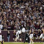 
              Texas A&M wide receiver Ainias Smith (0) reacts with teammate Kenyon Green (55) after returning a punt 95 yards for a touchdown against South Carolina during an NCAA college football game on Saturday, Oct. 23, 2021, in College Station, Texas. (AP Photo/Sam Craft)
            