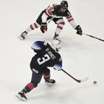 
              United States' Cayla Barnes scores a goal as Canada's Sarah Fillier, top defends in the first period of a women's hockey game in a pre-Olympic Games series Monday, Oct. 25, 2021, in Hartford, Conn. (AP Photo/Jessica Hill)
            