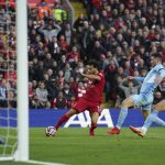 
              Liverpool's Mohamed Salah scores his side's second goal  during the English Premier League soccer match between Liverpool and Manchester City at Anfield, Liverpool, England, Sunday Oct. 3, 2021. (Peter Byrne/PA via AP)
            