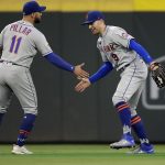 
              New York Mets' Brandon Nimmo, right, and Kevin Pillar (11) celebrate the 4-3 win over the Atlanta Braves after a baseball game Friday, Oct. 1, 2021, in Atlanta. (AP Photo/Ben Margot)
            
