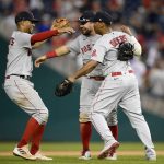 
              Boston Red Sox's Xander Bogaerts, left, Kyle Schwarber, center and Rafael Devers, right, celebrate after a baseball game against the Washington Nationals, Sunday, Oct. 3, 2021, in Washington. (AP Photo/Nick Wass)
            