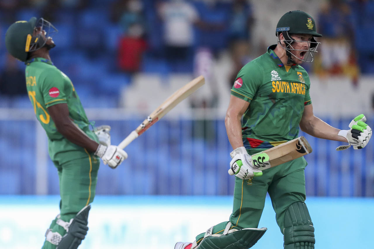 South Africa's David Miller, right, celebrates with teammate Kagiso Rabada after defeating Sri Lank...