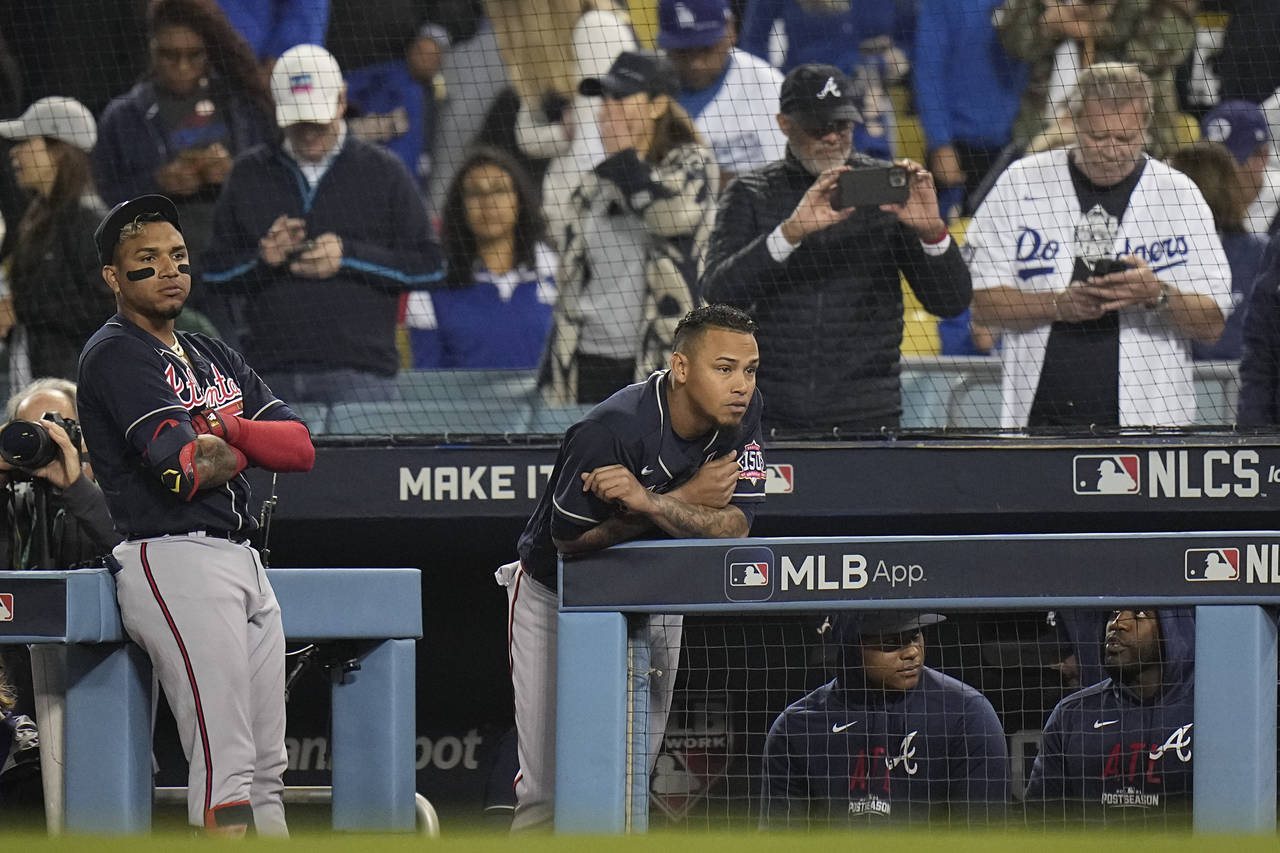 Atlanta Braves watch the ninth inning against the Los Angeles Dodgers from the dugout in Game 5 of ...