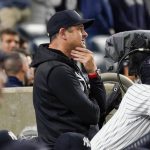 
              New York Yankees manager Aaron Boone watches the game from the dugout in the seventh inning of a baseball game against the Tampa Bay Rays, Friday, Oct. 1, 2021, in New York. (AP Photo/Mary Altaffer)
            
