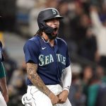
              Seattle Mariners' J.P. Crawford, right, celebrates with Jake Bauers after both scored against the Los Angeles Angels in the eighth inning of a baseball game Saturday, Oct. 2, 2021, in Seattle. (AP Photo/Elaine Thompson)
            