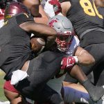 
              Washington State's Ron Stone Jr. (10) wraps up Arizona State running back DeaMonte Trayanum (1) during the first half of an NCAA college football game, Saturday, Oct 30, 2021, in Tempe, Ariz. (AP Photo/Darryl Webb)
            