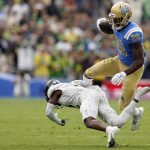 
              UCLA running back Brittain Brown (28) leaps over an Oregon defender during the first half of an NCAA college football game Saturday, Oct. 23, 2021, in Pasadena, Calif. (AP Photo/Marcio Jose Sanchez)
            