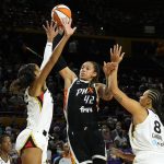 
              Phoenix Mercury center Brittney Griner (42) drives between Las Vegas Aces forward A'ja Wilson and center Liz Cambage (8) during the first half of a WNBA basketball game Sunday, Oct. 3, 2021, in Phoenix. (AP Photo/Rick Scuteri)
            