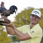 
              Sam Burns holds the champion's trophy after winning the Sanderson Farms Championship golf tournament in Jackson, Miss., Sunday, Oct. 3, 2021. (AP Photo/Rogelio V. Solis)
            