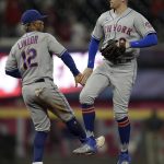 
              New York Mets' Brandon Nimmo, right, and Francisco Lindor (12) celebrate the 4-3 win over the Atlanta Braves after a baseball game Friday, Oct. 1, 2021, in Atlanta. (AP Photo/Ben Margot)
            