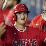 
              Los Angeles Angels' Shohei Ohtani is greeted in the dugout after he hit a solo home run during the first inning of a baseball game against the Seattle Mariners, Sunday, Oct. 3, 2021, in Seattle. (AP Photo/Ted S. Warren)
            