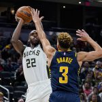 
              Milwaukee Bucks forward Khris Middleton (22) shoots over Indiana Pacers guard Chris Duarte (3) during the second half of an NBA basketball game in Indianapolis, Monday, Oct. 25, 2021. (AP Photo/Michael Conroy)
            