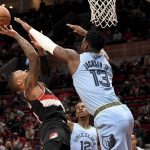 
              Portland Trail Blazers guard Damian Lillard, left, drives to the basket on Memphis Grizzlies forward Jaren Jackson Jr., right, during the first half of an NBA basketball game in Portland, Ore., Wednesday, Oct. 27, 2021. (AP Photo/Steve Dykes)
            