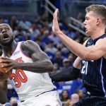 
              New York Knicks' Julius Randle (30) looks for a way past Orlando Magic's Moritz Wagner during the first half of an NBA basketball game Friday, Oct. 22, 2021, in Orlando, Fla. (AP Photo/John Raoux)
            