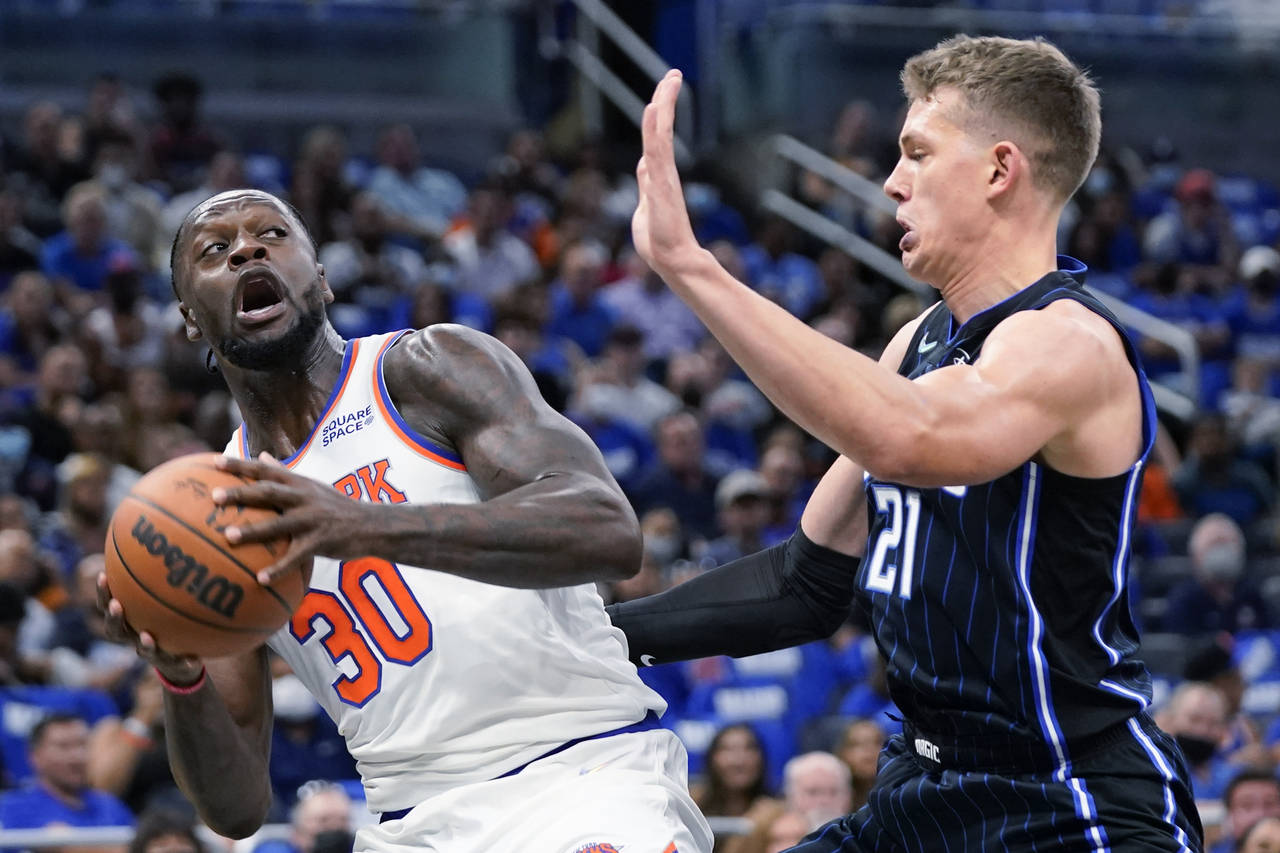 New York Knicks' Julius Randle (30) looks for a way past Orlando Magic's Moritz Wagner during the f...