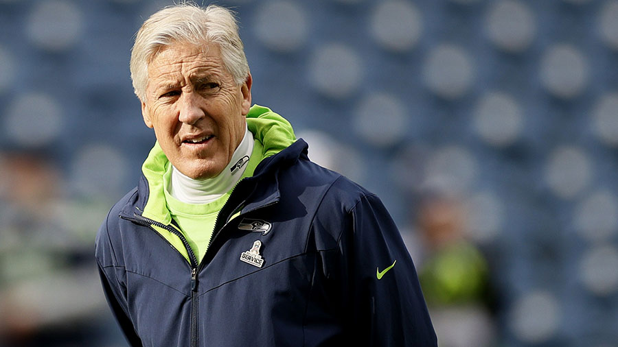 Seattle Seahawks head coach Pete Carroll, right, talks to line