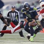 SEATTLE, WASHINGTON - NOVEMBER 21: Russell Wilson #3 of the Seattle Seahawks drops the ball as he is sacked during the first quarter against the Arizona Cardinals at Lumen Field on November 21, 2021 in Seattle, Washington. (Photo by Steph Chambers/Getty Images)