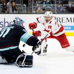 SEATTLE, WASHINGTON - NOVEMBER 24: Philipp Grubauer #31 of the Seattle Kraken makes a save against Jordan Martinook #48 of the Carolina Hurricanes during the third period at Climate Pledge Arena on November 24, 2021 in Seattle, Washington. (Photo by Steph Chambers/Getty Images)