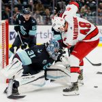 SEATTLE, WASHINGTON - NOVEMBER 24: Philipp Grubauer #31 of the Seattle Kraken makes a save against Jordan Martinook #48 of the Carolina Hurricanes during the third period at Climate Pledge Arena on November 24, 2021 in Seattle, Washington. (Photo by Steph Chambers/Getty Images)