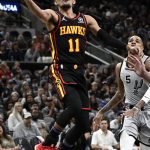 
              Atlanta Hawks' Trae Young (11) shoots during the first half of an NBA basketball game against the San Antonio Spurs, Wednesday, Nov. 24, 2021, in San Antonio. (AP Photo/Darren Abate)
            
