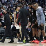 
              Miami Heat forward Markieff Morris, center right, is escorted off the court after he was involved in an altercation with Denver Nuggets center Nikola Jokic in the second half of an NBA basketball game Monday, Nov. 8, 2021, in Denver. (AP Photo/David Zalubowski)
            