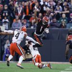 
              Cincinnati Bengals' Ja'Marr Chase (1) leaps over Cleveland Browns' Troy Hill (23) during the second half of an NFL football game, Sunday, Nov. 7, 2021, in Cincinnati. (AP Photo/Bryan Woolston)
            