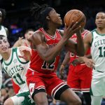 
              Chicago Bulls' Ayo Dosunmu, center, looks to shoot against Boston Celtics' Payton Pritchard (11) and Grant Williams, right, during the first half of an NBA basketball game, Monday, Nov. 1, 2021, in Boston. (AP Photo/Michael Dwyer)
            