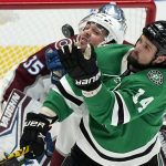 
              Dallas Stars left wing Jamie Benn (14) reaches for the puck in front of Colorado Avalanche defenseman Samuel Girard during the first period of an NHL hockey game in Dallas, Friday, Nov. 26, 2021. (AP Photo/LM Otero)
            