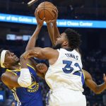 
              Minnesota Timberwolves center Karl-Anthony Towns (32) is defended by Golden State Warriors center Kevon Looney, left, during the first half of an NBA basketball game in San Francisco, Wednesday, Nov. 10, 2021. (AP Photo/Jeff Chiu)
            