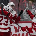 
              Detroit Red Wings right wing Lucas Raymond (23), center Dylan Larkin (71) and defenseman Filip Hronek (17) celebrate the game-wining goal by Larkin after an NHL hockey game against the Washington Capitals, Wednesday, Oct. 27, 2021, in Washington. The Red Wings won 3-2 in overtime. (AP Photo/Alex Brandon)
            