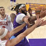 
              Los Angeles Lakers forward Anthony Davis, right, grabs a rebound away from Chicago Bulls guard Alex Caruso, lower left, and forward Derrick Jones Jr., second from right, as guard Lonzo Ball watches during the first half of an NBA basketball game Monday, Nov. 15, 2021, in Los Angeles. (AP Photo/Mark J. Terrill)
            