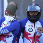 
              Kaillie Humphries of the United States, left, and her team mate Elana Meyers Taylor watch the leaderboard during the women's Bobsled World Cup race in Igls, near Innsbruck, Austria, Saturday, Nov. 20, 2021. (AP Photo/Matthias Schrader)
            