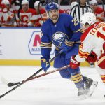 
              Buffalo Sabres left wing Vinnie Hinostroza (29) and Calgary Flames left wing Matthew Tkachuk (19) battle for the puck during the first period of an NHL hockey game, Thursday, Nov. 18, 2021, in Buffalo, N.Y. (AP Photo/Jeffrey T. Barnes)
            