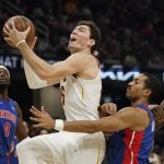 
              Cleveland Cavaliers' Cedi Osman, left, drives to the basket against Detroit Pistons' Jerami Grant in the first half of an NBA basketball game, Friday, Nov. 12, 2021, in Cleveland. (AP Photo/Tony Dejak)
            