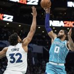
              Charlotte Hornets forward Miles Bridges (0) shoots over Minnesota Timberwolves center Karl-Anthony Towns (32) during the first half of an NBA basketball game in Charlotte, N.C., Friday, Nov. 26, 2021. (AP Photo/Jacob Kupferman)
            