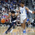 
              Gonzaga guard Julian Strawther, left, brings the ball up next to Duke forward Wendell Moore Jr. (0) during the first half of an NCAA college basketball game Friday, Nov. 26, 2021, in Las Vegas. (AP Photo/Ellen Schmidt)
            