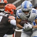 
              Cleveland Browns middle linebacker Anthony Walker (4) tries to tackle Detroit Lions wide receiver Amon-Ra St. Brown (14) during the first half of an NFL football game, Sunday, Nov. 21, 2021, in Cleveland. (AP Photo/Ron Schwane)
            