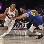 
              Portland Trail Blazers guard Anfernee Simons, left, drives on Denver Nuggets guard Austin Rivers during the second half of an NBA basketball game in Portland, Ore., Tuesday, Nov. 23, 2021. (AP Photo/Steve Dipaola)
            