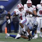 
              SMU running back Tre Siggers (4) carries the ball against Memphis in the first half of an NCAA college football game Saturday, Nov. 6, 2021, in Memphis, Tenn. (AP Photo/Mark Humphrey)
            