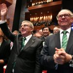 
              FILE - Then President of the Rio 2016 Olympic Organizing Committee Carlos Arthur Nuzman, right, and International Olympic Committee President Thomas Bach, second right, applaud during the opening ceremony of the 129th International Olympic Committee session, in Rio de Janeiro on August 1, 2016, ahead of the Rio 2016 Olympic Games. Nuzman, the head of the Brazilian Olympic Committee for more than two decades, was sentenced to 30 years and 11 months in jail for allegedly buying votes for Rio de Janeiro to host the 2016 Olympics. The ruling by Judge Marcelo Bretas became public Thursday, Nov. 25, 2021. (Fabrice Coffrini/Pool Photo via AP, File)
            