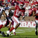 
              Arkansas receiver Treylon Burks (16) tries to get past Mississippi State defender Decamerion Richardson (30) as he runs the ball during the first half of an NCAA college football game Saturday, Nov. 6, 2021, in Fayetteville, Ark. (AP Photo/Michael Woods)
            