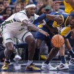 
              Milwaukee Bucks center Bobby Portis (9) and Indiana Pacers guard Caris LeVert (22) battle for the ball during the first half of an NBA basketball game in Indianapolis, Sunday, Nov. 28, 2021. (AP Photo/Doug McSchooler)
            