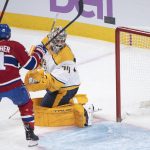 
              Nashville Predators goaltender Juuse Saros, right, looks back after being scored against by Montreal Canadiens' Brendan Gallagher (11) during second-period NHL hockey game action in Montreal, Saturday, Nov. 20, 2021. (Graham Hughes/The Canadian Press via AP)
            