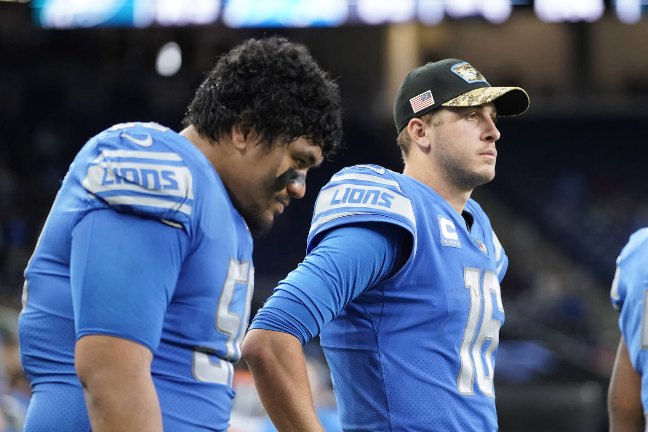 Detroit Lions offensive tackle Penei Sewell, left, and quarterback Jared Goff are sen in the bench ...